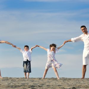 happy young family have fun and live healthy lifestyle on beach