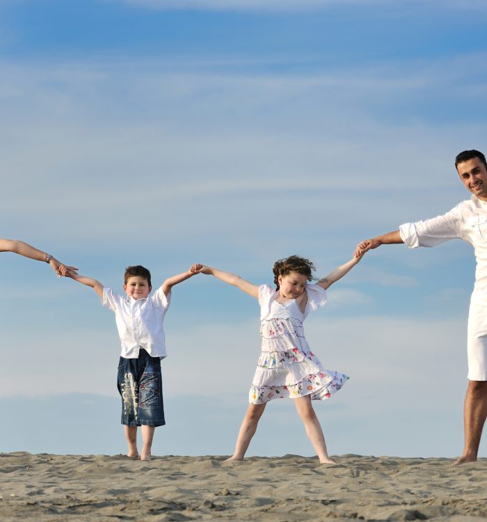 happy young family have fun and live healthy lifestyle on beach