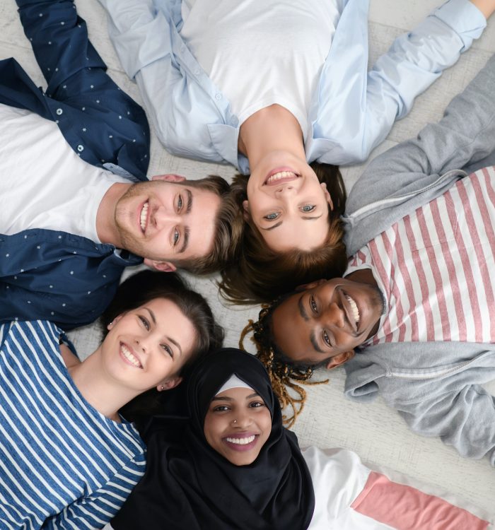 a top view of a diverse group of people lying on the floor and symbolizing togetherness