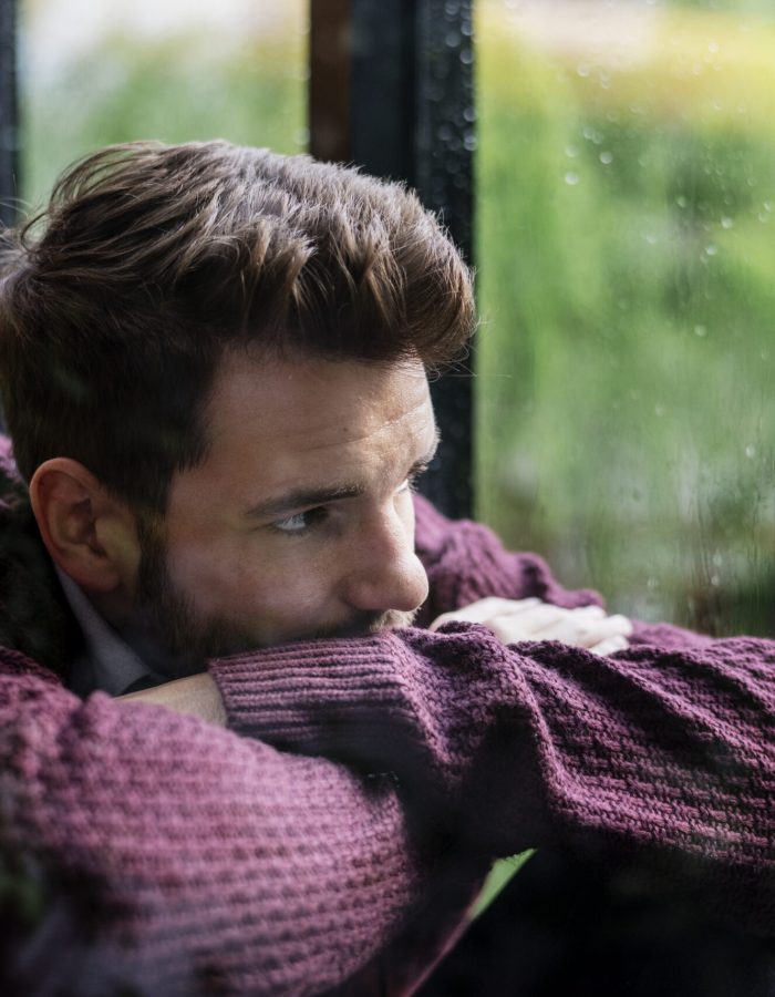 Thoughtful man looking out the window